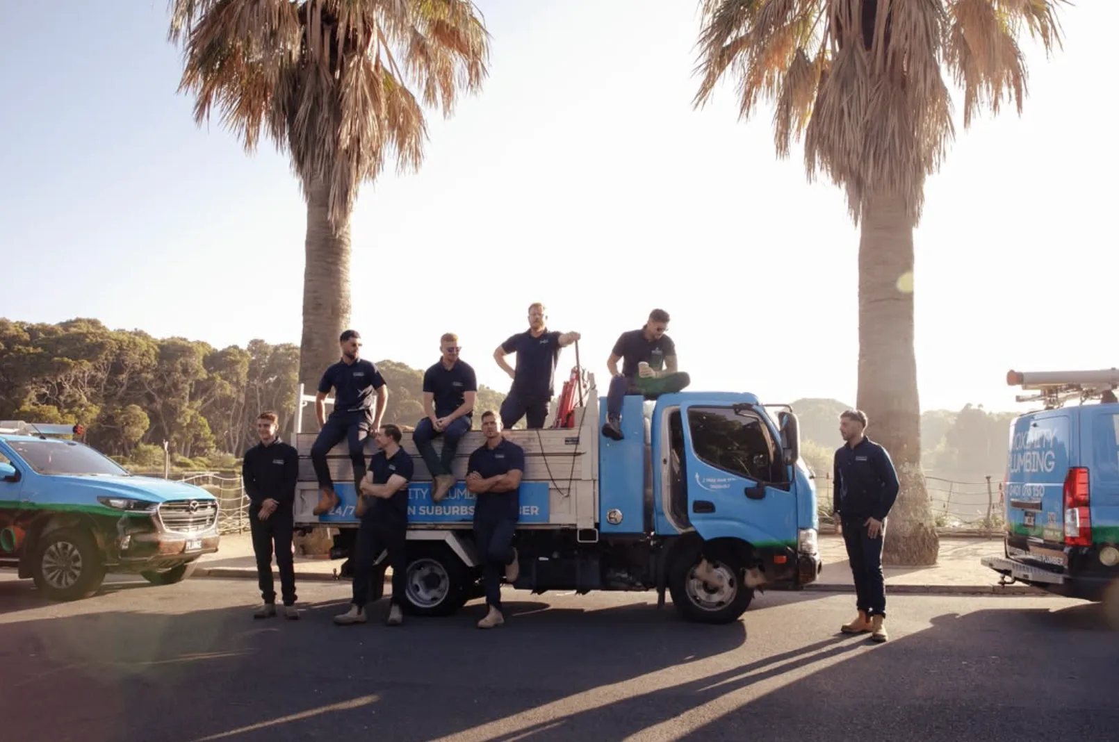The drain crew with their trucks by the beach